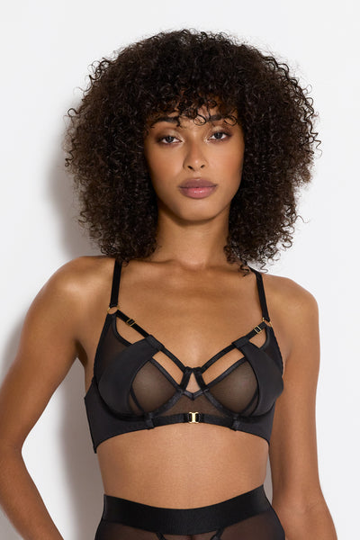 Bordelle Vero Balconette underwire bra in black, featuring movable jersey panels over sheer mesh cups with strappy detailing and 24k gold plated hardware. Front view on model. 