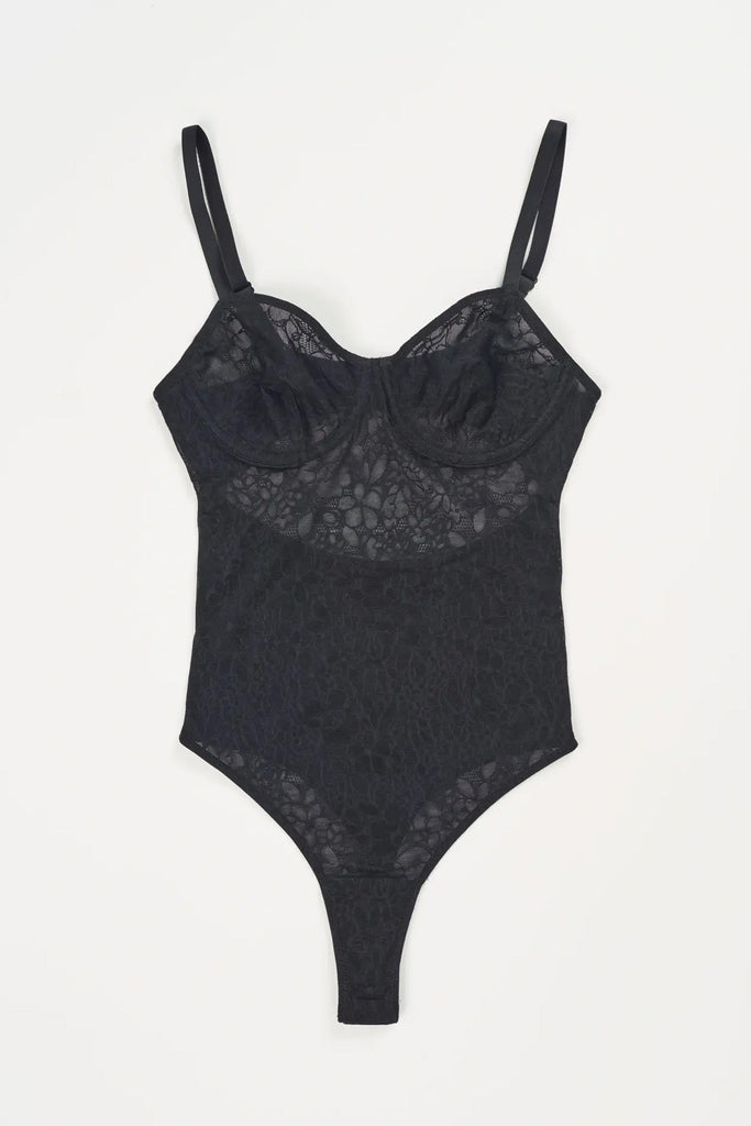 Else Eden black lace mesh underwire bodysuit, shown flat on plain white background. Image shows thin elastic shoulder straps, back cutout and thong bottom with cotton lined gusset.