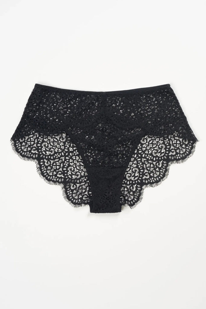 Else Monique black lace retro brief shown flat on plain white background. Lace features a scalloped edge with eyelash detail and a swirling geometric pattern.
