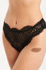 Else Monique black lace high waist thong. Front view, shown on model. Thong features a mid-high rise waistline with the scalloped edge of the lace on the leg line and waistline. 