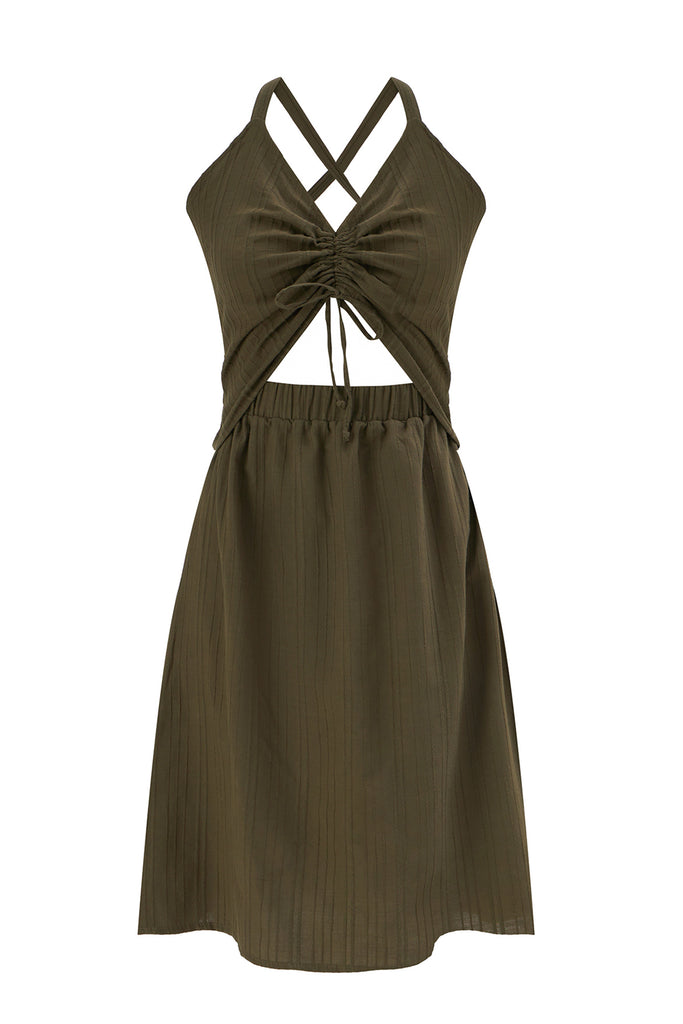 Else Ponza cotton dress in khaki green. The dress features a deep v neckline, halter style straps, a ruched front with tie closure, midriff cutout, elastic waistband, and an a-line knee length skirt. Shown on plain white background.
