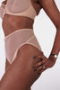 High waist sheer nude All Talk panties from la Fille d'o. Side view on model.