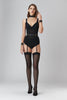 Murmur Grid bodysuit in black stretch muslin. Sleeveless opaque plunge top and bust with sheer midsection, and opaque bottom. Front view on model shown with matching stockings and suspender belt.. 