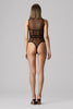 Murmur Cage black sheer mesh bodysuit with graphic black trim under shoulder blades, around waist, and vertically on torso. High cut neck and legs, thong bottom, sleeveless design. Back view on model.