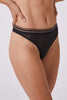 Opaak Anou thong in black sheer mesh, front/side view on model