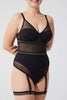 Opaak Lil leg strap garter in black, attached to matching Lux bodysuit, front view, on model