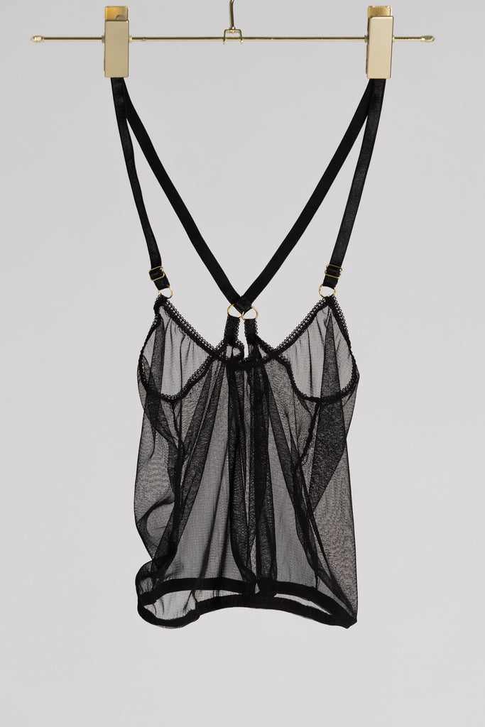 Sheer black Eartha cropped camisole by Adrina Dietra. Shown hanging from a golden hanger against a white background.
