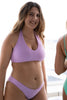Light fairy purple Canggu bikini swim bottom by Copenhagen Cartel. Front/side view on model with matching swim top.
