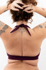 Dark purple Bukit halter swim top with tie behind the neck by Copenhagen Cartel. Back view on model.