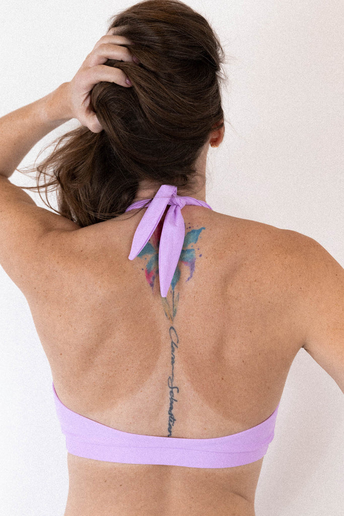 Light fairy purple Bukit halter swim top with tie behind the neck by Copenhagen Cartel. Back view on model.