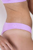Fairy purple Canggu swim bottom. Side view on model shows small Copenhagen Cartel logo at the hip.