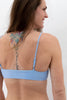 Light blue Sanur swim top with thin adjustable straps by Copenhagen Cartel. Back view on model.