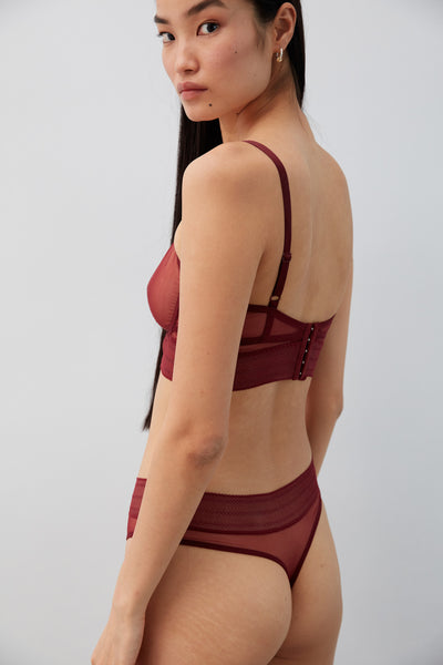 Else Bare sheer mesh thong in dark burgundy Bloodstone, shown on model with matching longline bra, back view