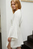 Else Diana silk robe in off white, side view shown on model. The photo shows the side slits, wide sleeves, and drop shoulders. 