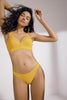 Saffron yellow Mare Underwire Sim top by Else with thick underband. Front view on model with matching bikini swim bottoms.