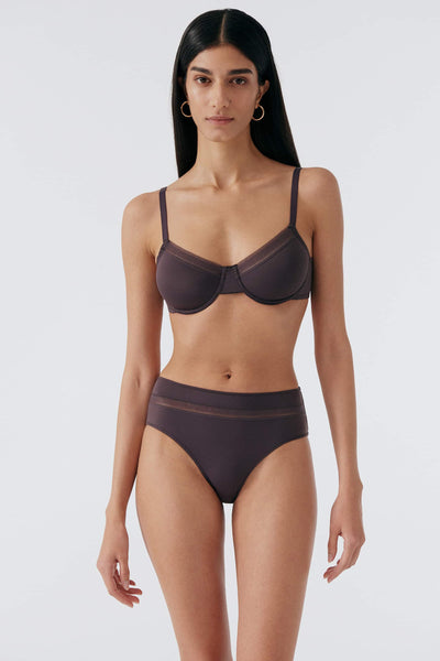 Else Nano everyday mid rise microfiber briefs in dark purple prune, shown with matching underwire bra, front view on model