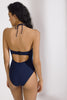 Deep Blue Penelope Bandeau one-piece Swimsuit by Else with skinny halter strap. Back view on standing model shows clasp at back and opening at the mid-back.