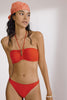 Poppy red orange Penelope bikini bottom by Else. Front view on model with matching bandeau swim top.