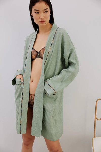 Else Constantinople robe in light green with abstract print silk trim on collar, cuffs and pockets. Front view on model, shown open with matching Ebru print lingerie set underneath.