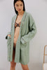 Else Constantinople robe in light green with abstract print silk trim on collar, cuffs and pockets. Front view on model, shown open with matching Ebru print lingerie set underneath.