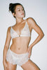 Only Hearts Sofia set with sheer white lace bralette and matching shorts. Front view on model shown with white thong.
