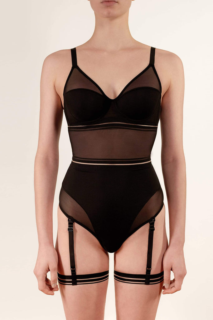 Opaak Lil leg strap garter in black, attached to matching Lux bodysuit, front view, on model
