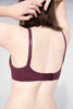 Opaak Magaly plunge underwire bra in Dawn (burgundy). Back view on model showing the two hook and eye closure and adjustable shoulder straps. The underband features a honeycomb textured fabric.