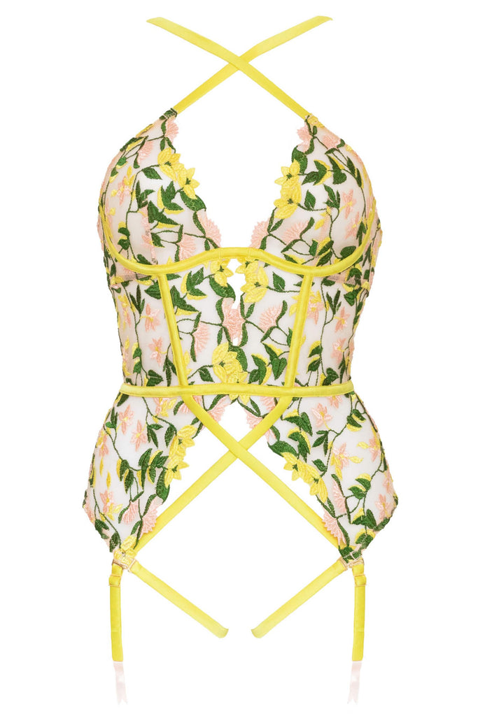 Chartreuse underwire basque with spring floral embroidery and straps that criss cross at the chest and stomach by Studio Pia. Front view on white background.