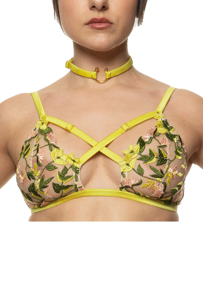 Liana bralette with gold hardware and chartreuse straps that criss cross at the chest by Studio Pia. Soft cups are sheer with spring floral embroidery.Front view on model.