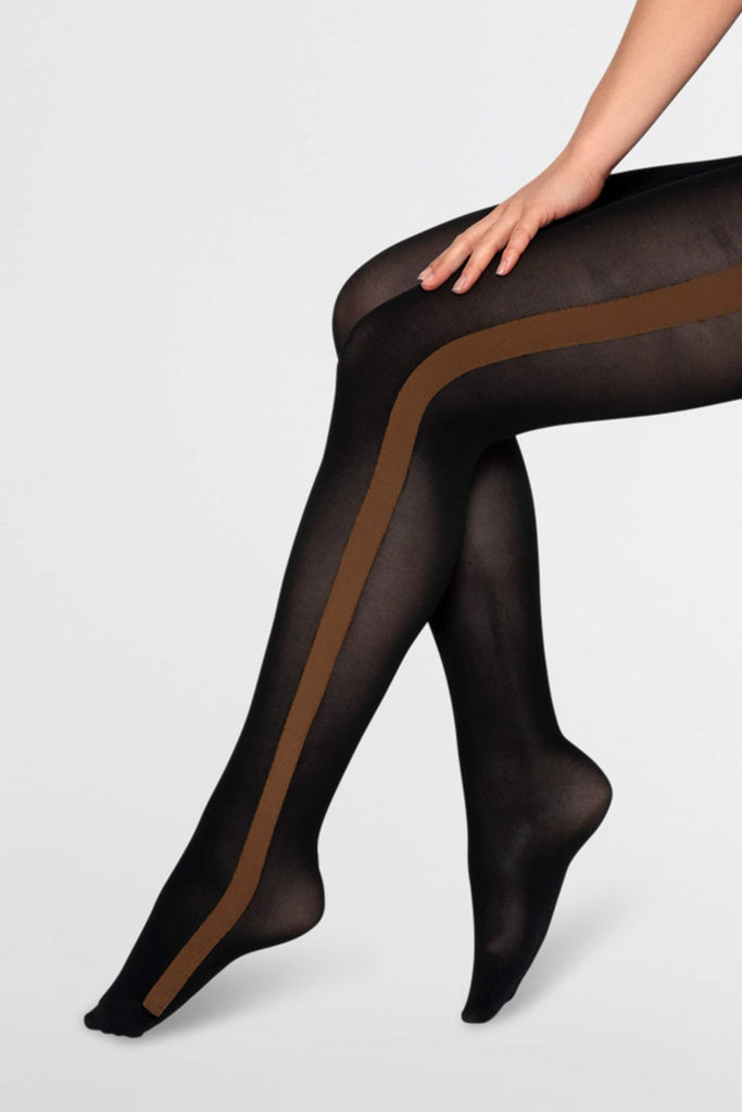 Black semi-opaque tights with brown strip from waist to toe from Swedish stockings. On model from waist down in front of plain white background.