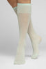 Swedish Stockings Doris Dots knee high mesh socks in light green with polka dots throughout, front/side view on model