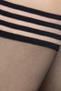 Swedish Stockings Mira stay up stockings in black, with striped banding around thighs, shown on model, detail view,