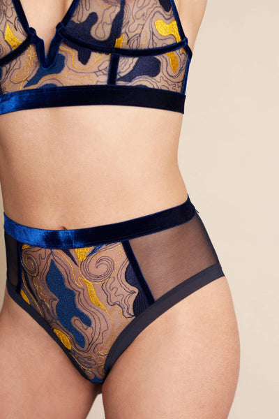 The Underargument Diversity Is Key high waist brief in deep navy blue velvet and mesh, with navy and golden yellow embroidery, front/side view shown on model