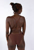 La Fille d'O Savage mid-high waist sheer mesh brief in chocolate brown. Minimal, high leg silhouette. Back view on model wearing matching Fast Girls monowire plunge bra with back straps crossed. 