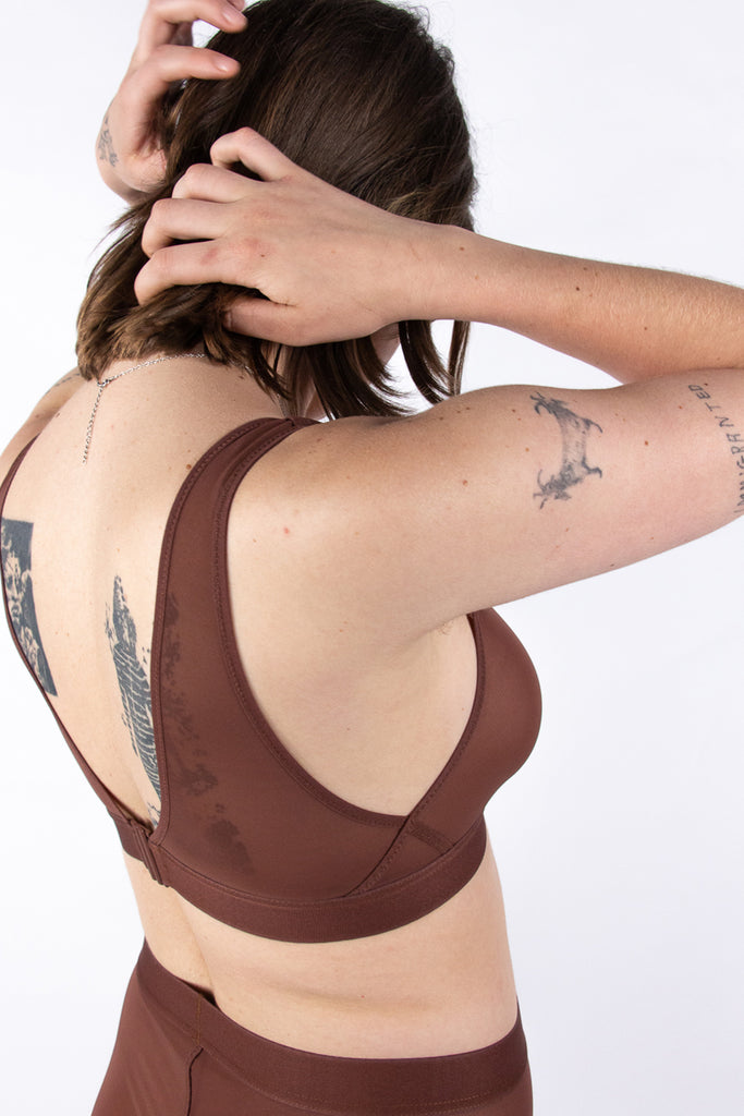 La Fille d'O Ramble On sheer mesh wireless bralette in chocolate brown. Side/back view on model showing low plunge back and criss cross seams under the arms. 