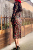 Only Hearts Betsey Rose sheer black mesh dress with green and red rose print, back view on model. Image shows midi length hemline and long sleeves. 